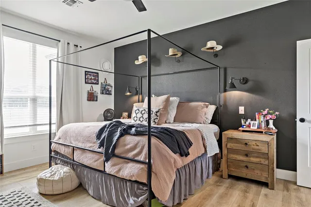 a bedroom with furniture and a window