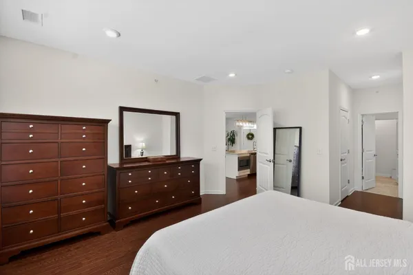 a bedroom with a bed and a dresser