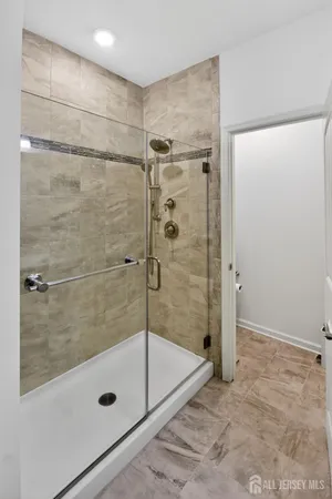 a bathroom with a glass door shower