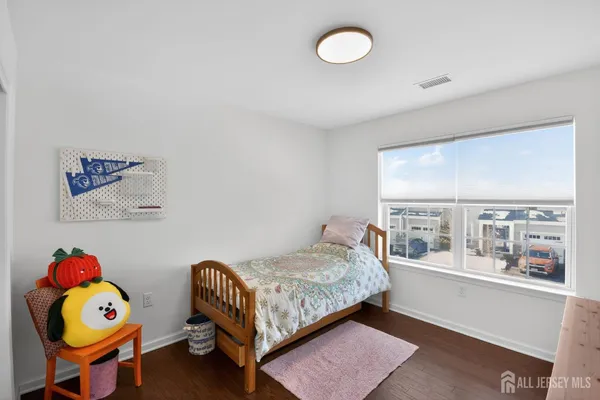 a bedroom with a bed and a large window