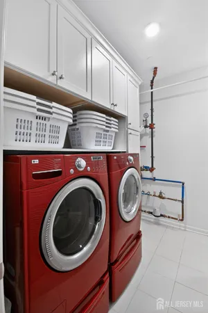 a utility room with sink dryer and washer