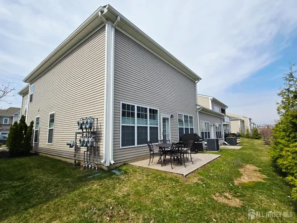 a backyard of a house with table and chairs