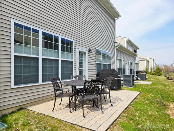 a view of a house with backyard and sitting area