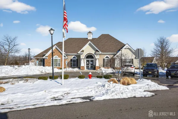 a view of house with snow on the road