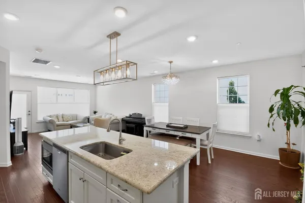 a kitchen with a counter space a sink and cabinets