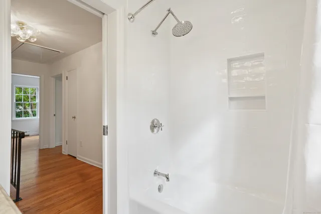 a bathroom with a bathtub and shower