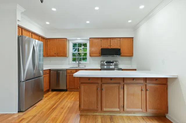 a kitchen with stainless steel appliances granite countertop a sink stove and refrigerator