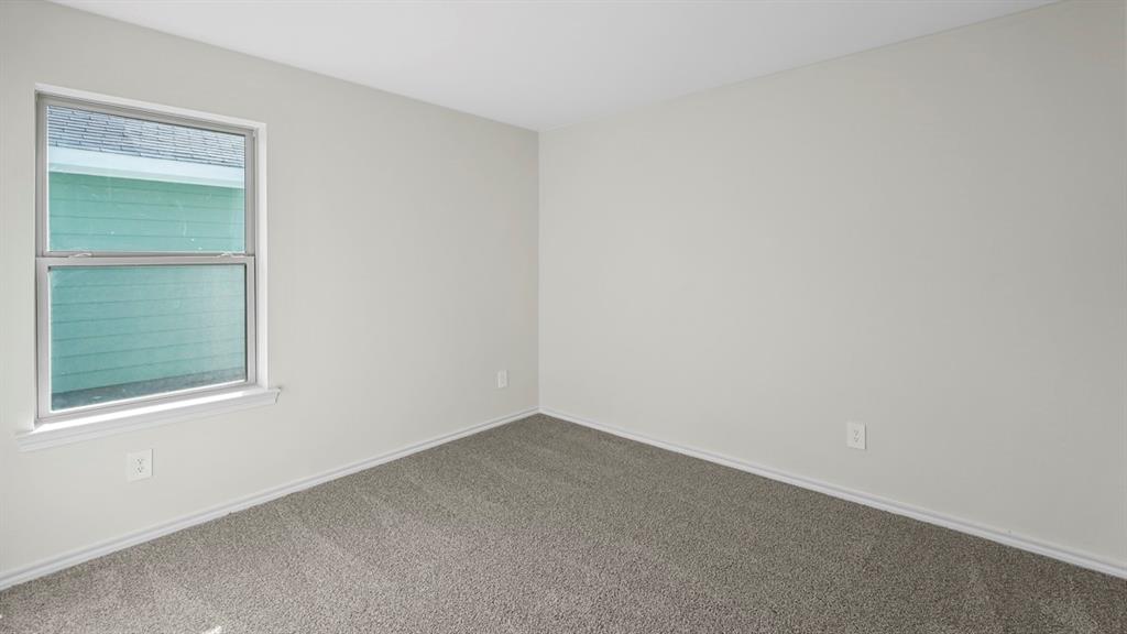 1953 Freeman Street Tyler, TX 75704 - Photo 23 of 32 Neutral tone walls with white trim and a double-hung window
