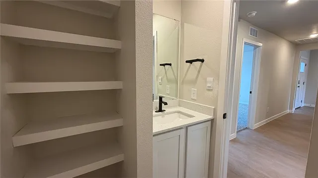 a bathroom with a tub sink and mirror