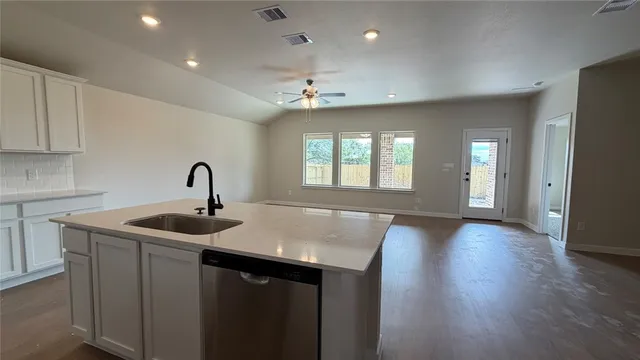 a kitchen with sink and mirror