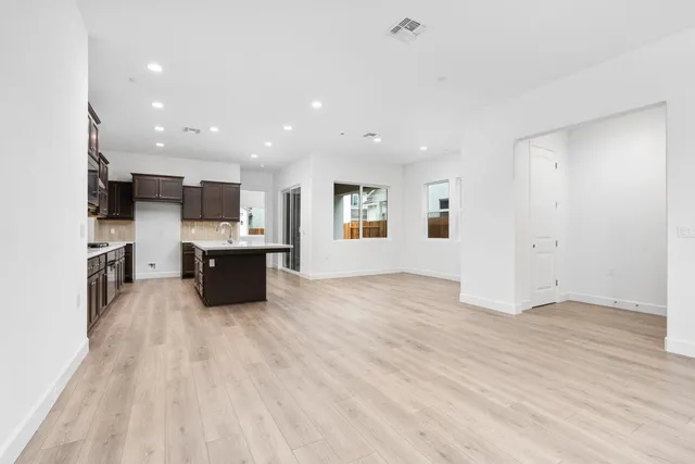 a view of kitchen with microwave cabinets and wooden floor