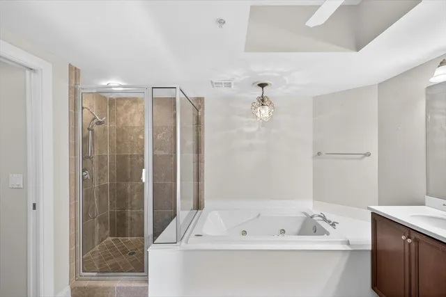 a large spacious bathroom with a large tub shower and sink