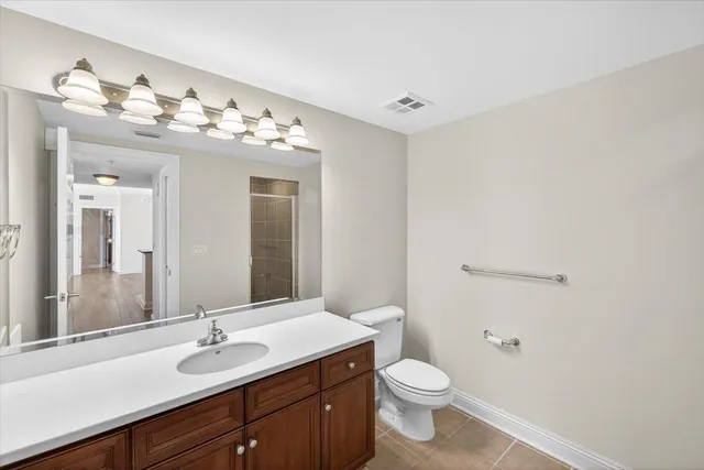 a view of a room with wooden floor and windows