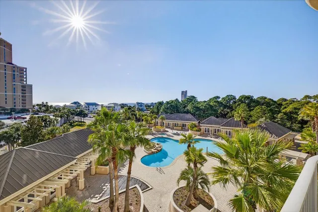 a view of a house with swimming pool and furniture