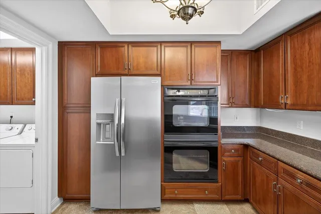 a kitchen with granite countertop stainless steel appliances and wooden cabinets