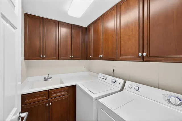 a large kitchen with stainless steel appliances granite countertop a stove and a refrigerator