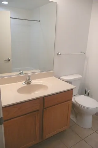 a bathroom with a sink toilet and a mirror