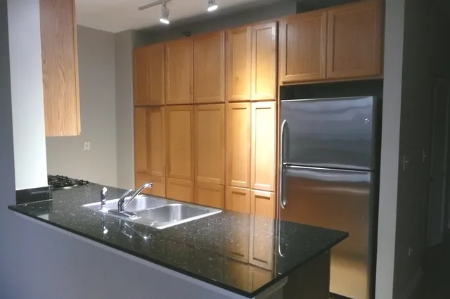 a kitchen with a refrigerator and countertop