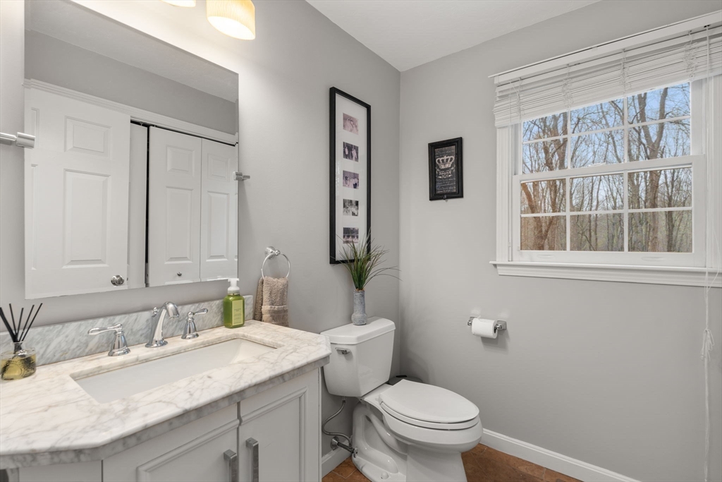 45 Auburn Road Millis, MA 02054 - Photo 15 of 31 a bathroom with a granite countertop sink mirror vanity and toilet