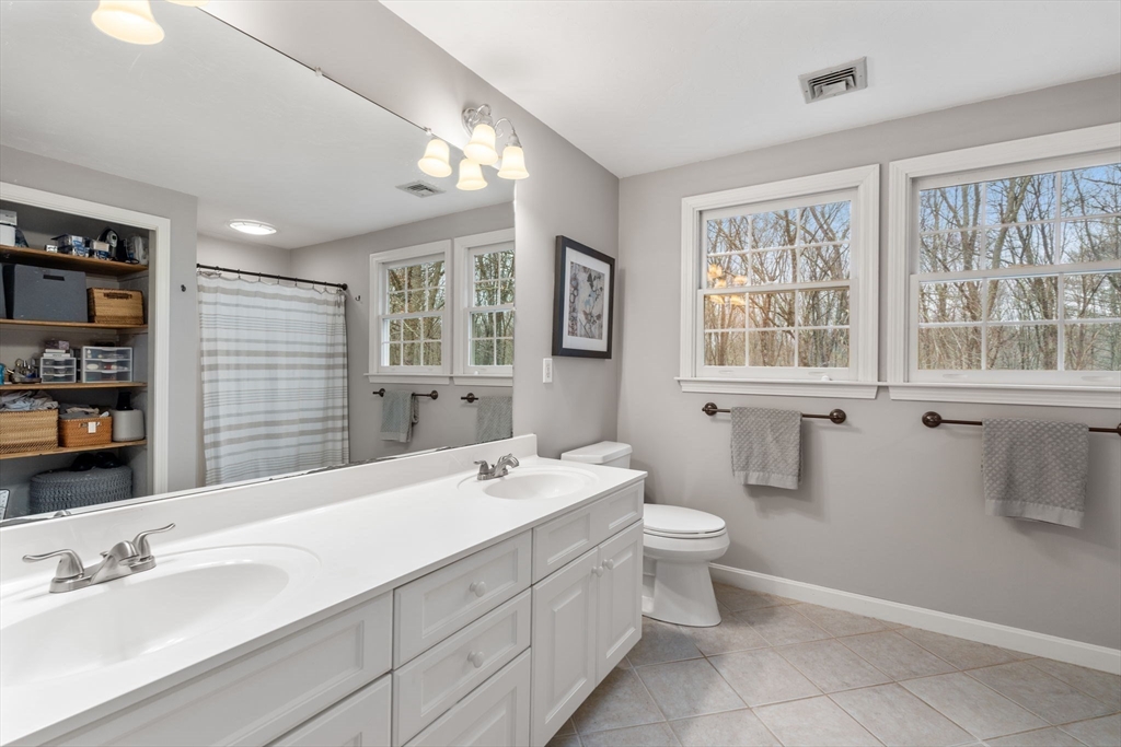 45 Auburn Road Millis, MA 02054 - Photo 19 of 31 a bathroom with a sink double vanity and a toilet