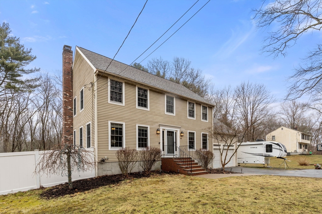 45 Auburn Road Millis, MA 02054 - Photo 2 of 31 a front view of house with yard covered in snow