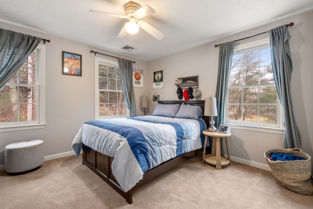 45 Auburn Road Millis, MA 02054 - Photo 21 of 31 a bedroom with a bed and a chandelier