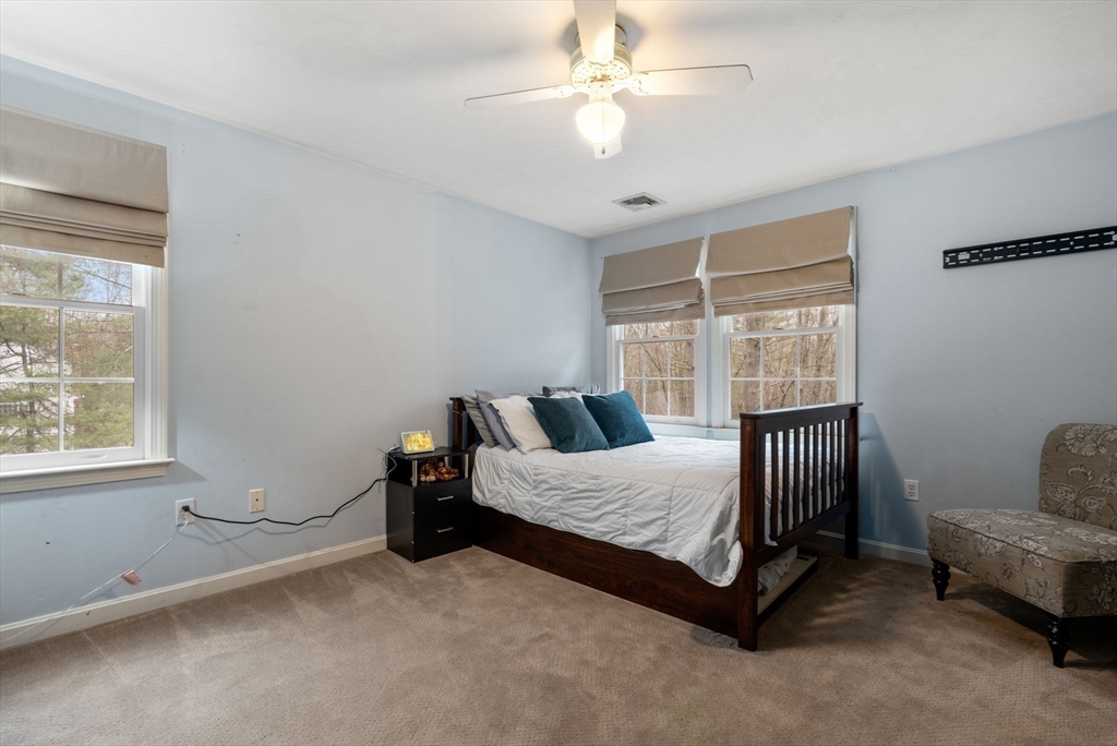 45 Auburn Road Millis, MA 02054 - Photo 23 of 31 a bedroom with a bed and a chandelier