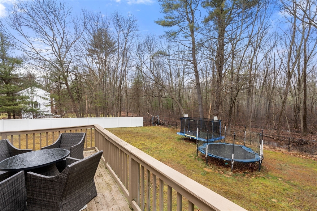 45 Auburn Road Millis, MA 02054 - Photo 28 of 31 a view of a swimming pool with chairs and wooden fence