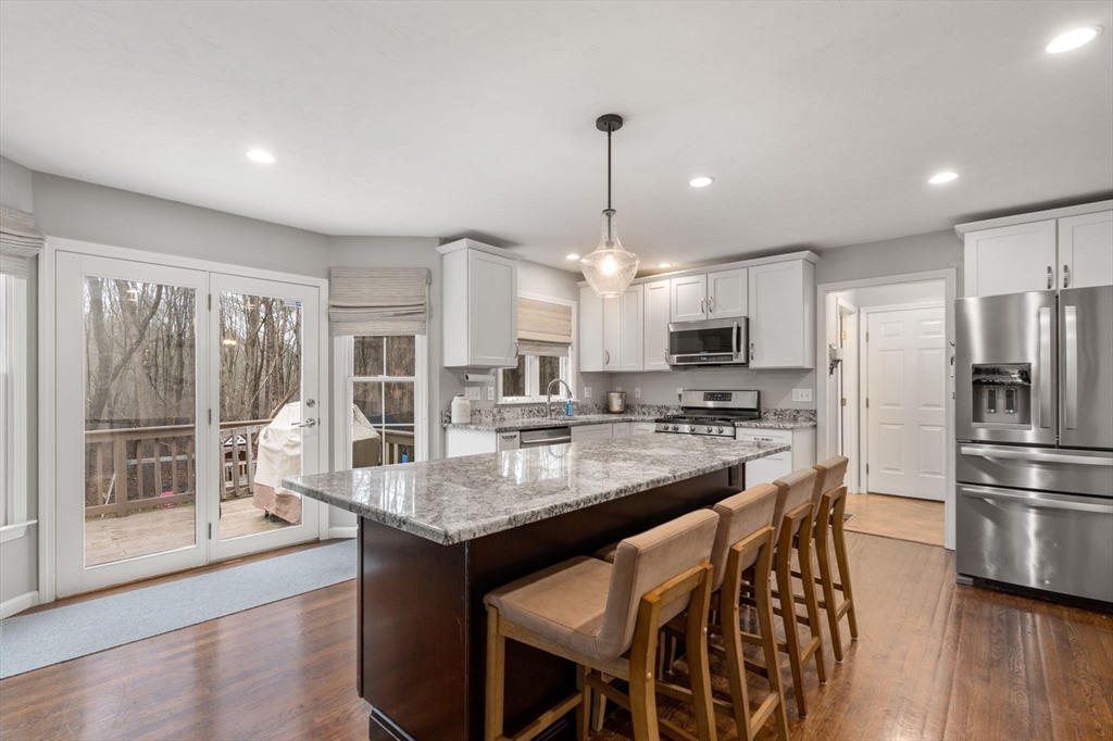 45 Auburn Road Millis, MA 02054 - Photo 5 of 31 a kitchen with kitchen island granite countertop a center island stainless steel appliances cabinets and a counter top space