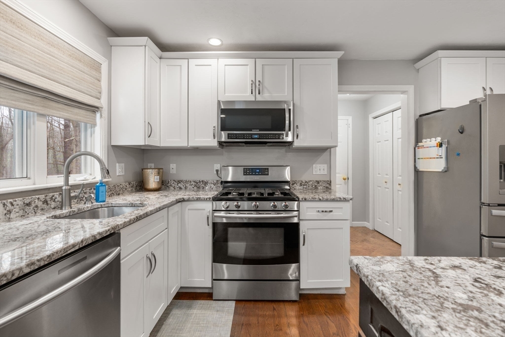 45 Auburn Road Millis, MA 02054 - Photo 6 of 31 a kitchen with granite countertop a sink stove and refrigerator