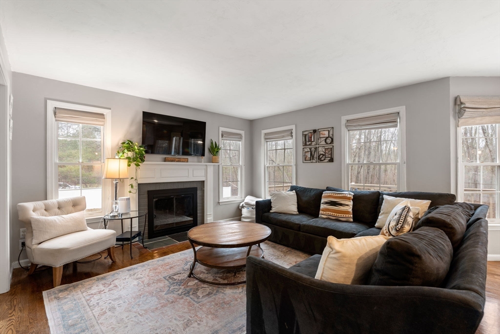 45 Auburn Road Millis, MA 02054 - Photo 10 of 31 a living room with furniture a fireplace and a flat screen tv