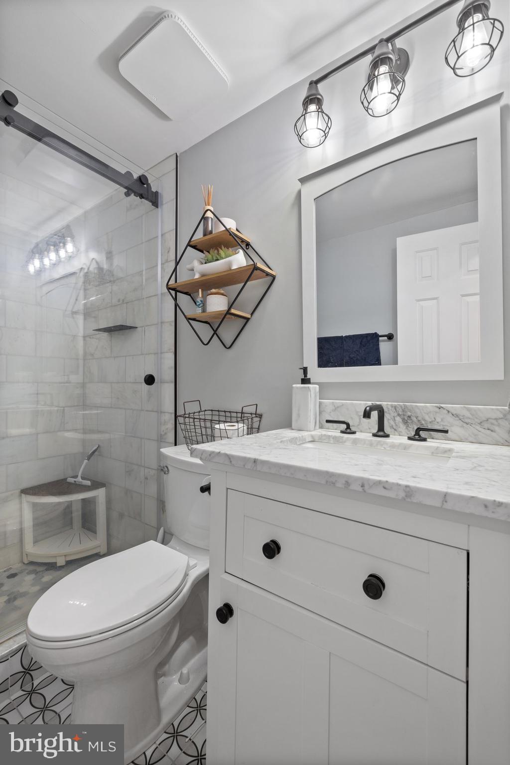 4181 Buffalo Road Mount Airy, MD 21771 - Photo 18 of 38 a bathroom with a granite countertop toilet sink and mirror