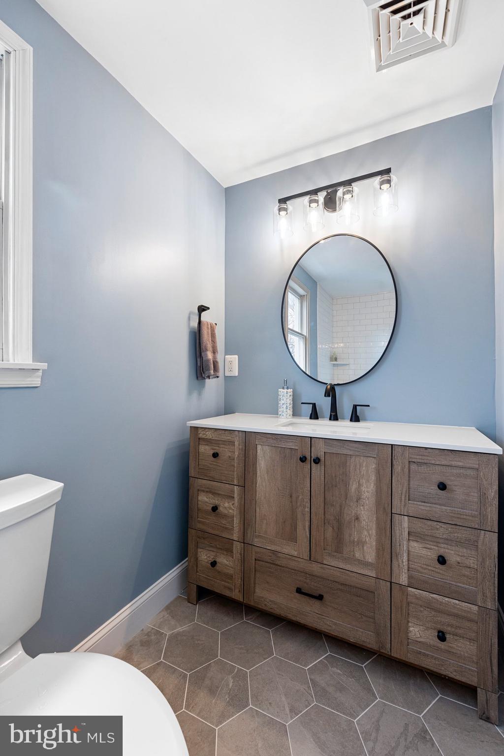 4181 Buffalo Road Mount Airy, MD 21771 - Photo 26 of 38 a bathroom with a toilet a sink and mirror