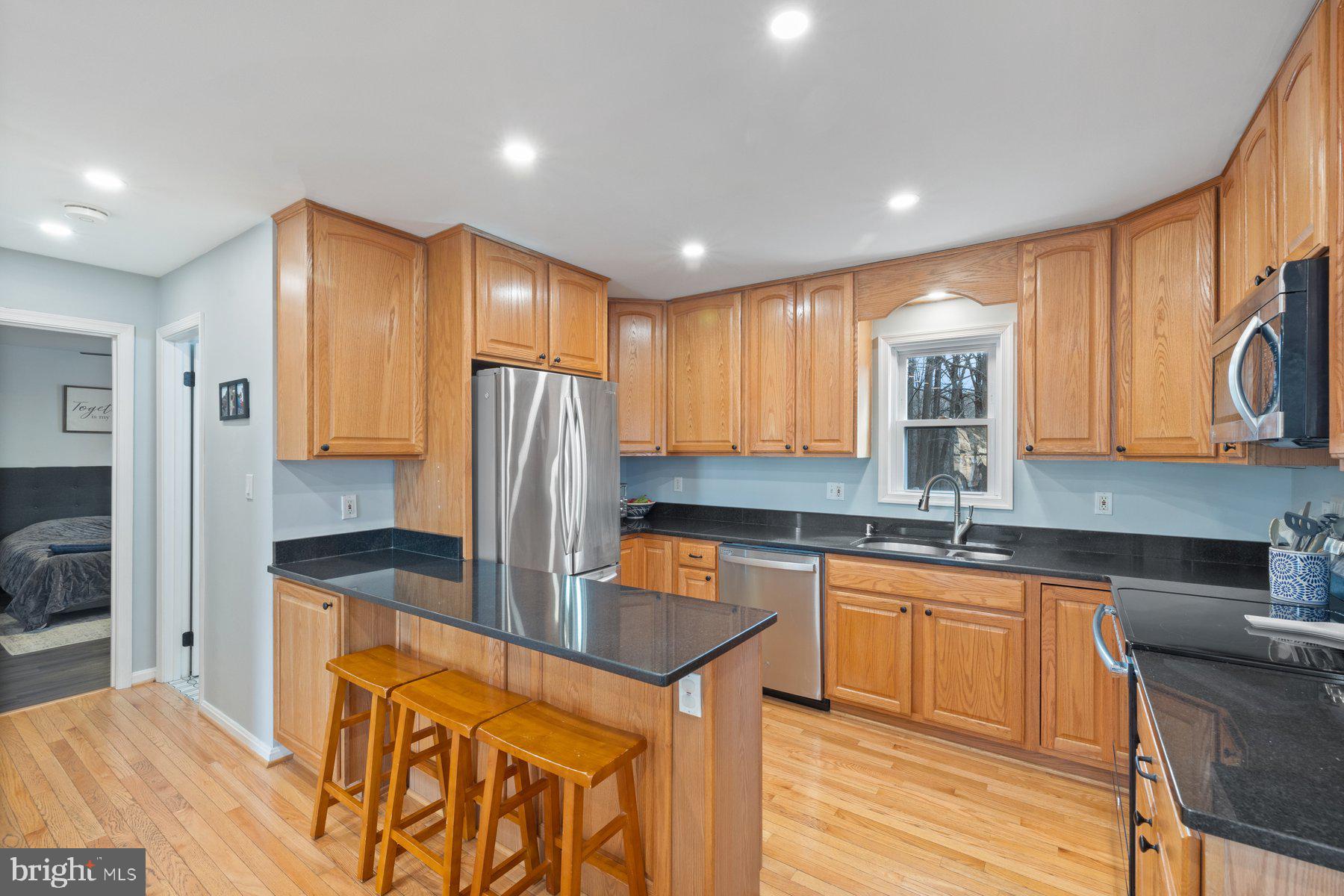 4181 Buffalo Road Mount Airy, MD 21771 - Photo 9 of 38 a kitchen with stainless steel appliances granite countertop a sink refrigerator and cabinets