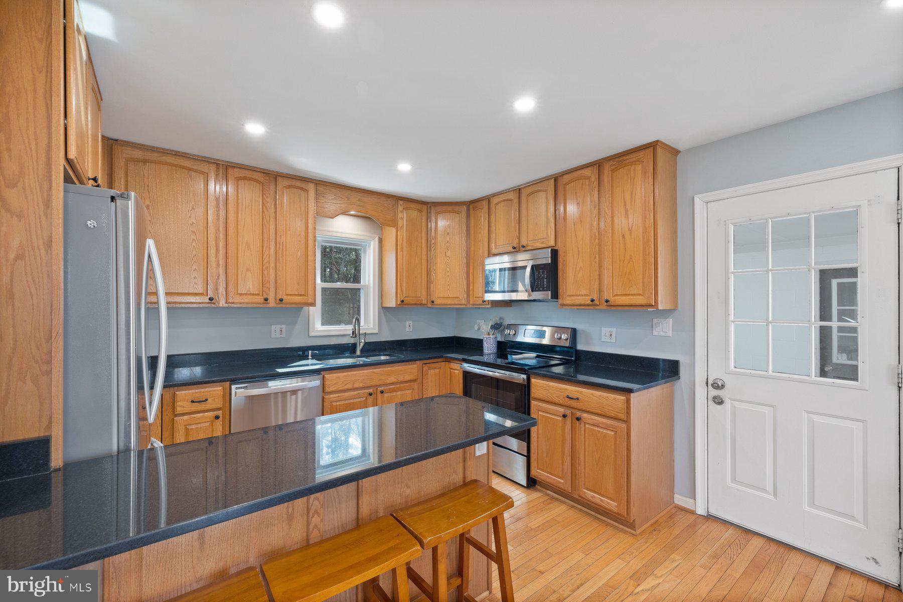 4181 Buffalo Road Mount Airy, MD 21771 - Photo 10 of 38 a kitchen with stainless steel appliances granite countertop a stove a sink and a refrigerator