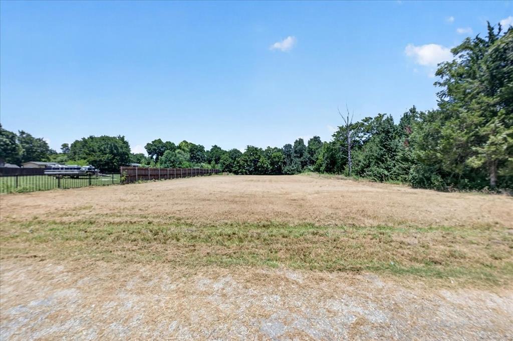 1306 Ranch Road Grand Prairie, TX 75052 - Photo 3 of 13 Expansive cleared lot with perimeter fencing and mature tree line