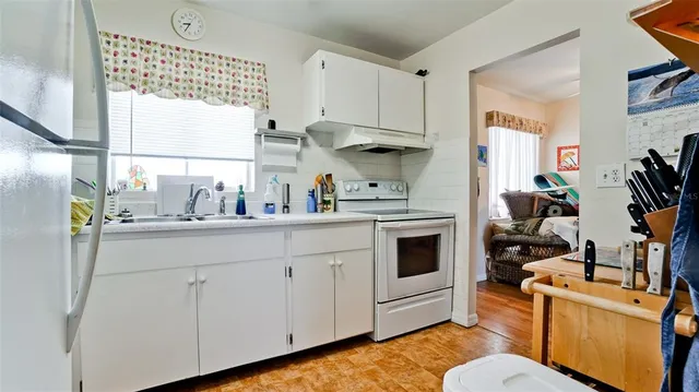 a kitchen with a sink appliances and cabinets