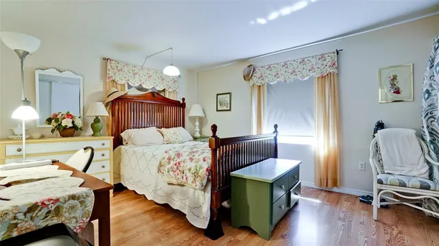 a bedroom with furniture and a wooden floor