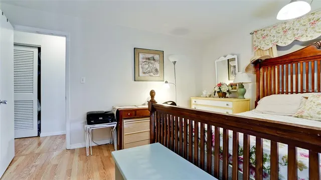a bedroom with furniture and a wooden floor