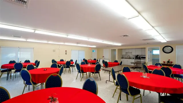 a kitchen with white cabinets and sink