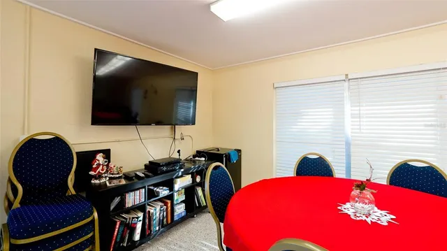 a view of a patio with table and chairs potted plants with wooden floor and fence