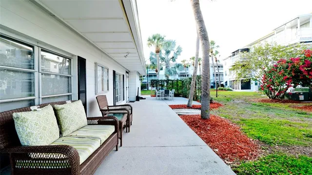 a view of a tennis ground with large trees