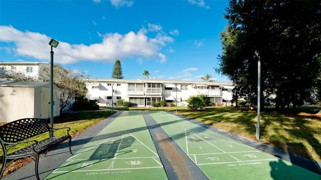 a view of a white house with a white walls and a dining table