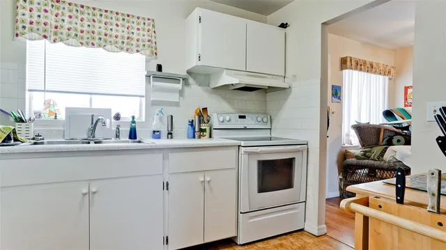 a kitchen with stainless steel appliances white cabinets and a sink