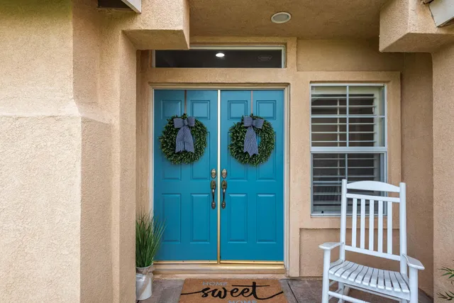 a view of a hallway with wooden floor and a window