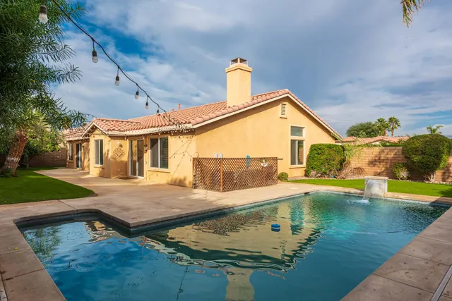 swimming pool view with a seating space