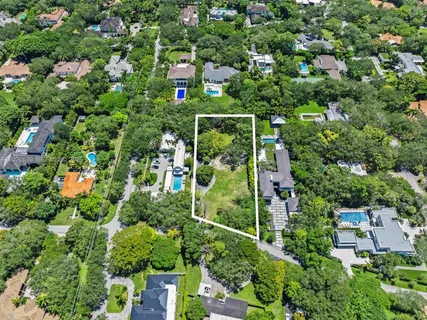 an aerial view of a house with outdoor space and street view