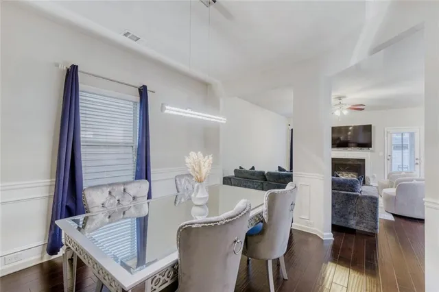 a dining room with furniture and wooden floor