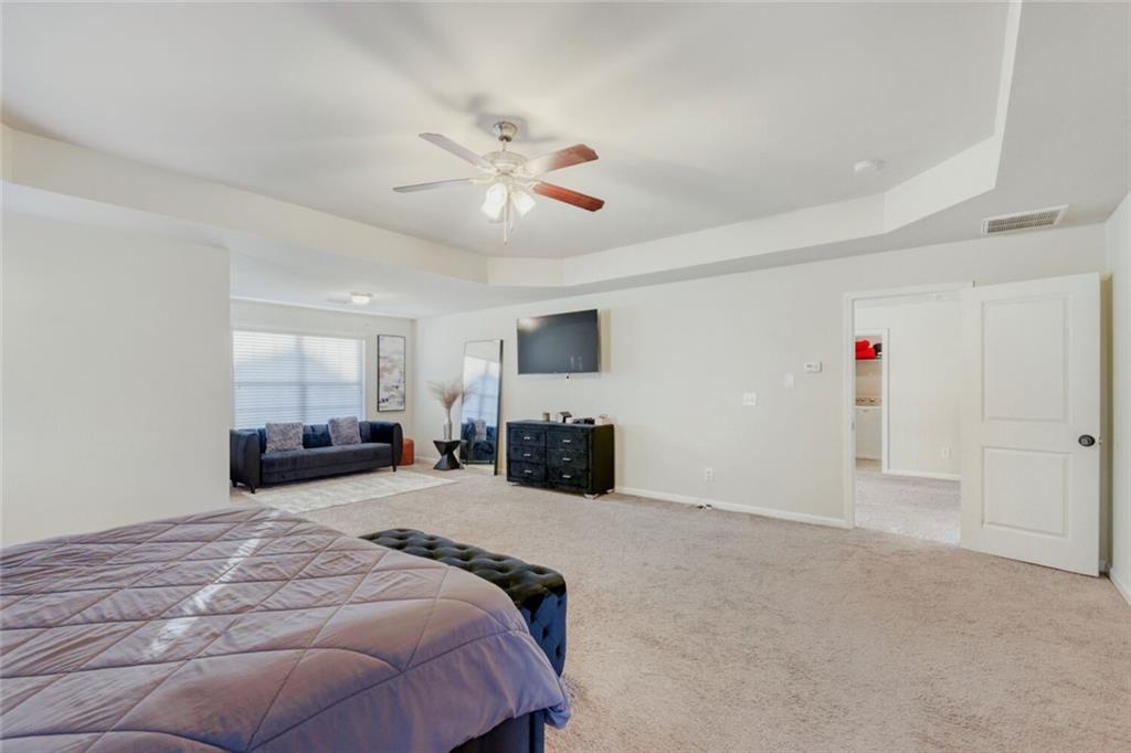 7607 Crawford Court Fairburn, GA 30213 - Photo 16 of 32 a bed room with a bed and a television