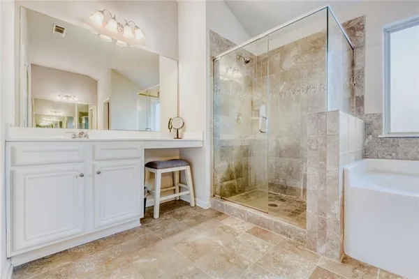 a bathroom with a shower a sink and a mirror